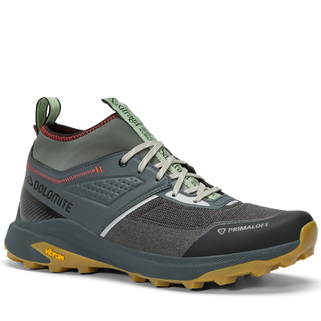 Gray hiking shoe with green accents on a white background