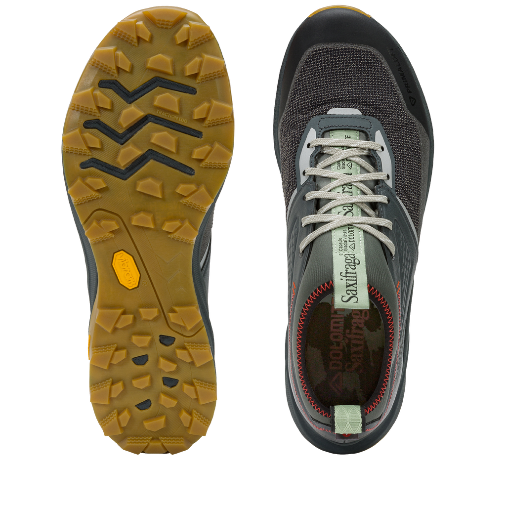 Gray athletic shoe with yellow sole on a white background