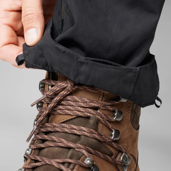 Fjallraven Men's Keb Trousers Model Kneel Close Up Leg Lower Detail Near Shoes Buckle Up Closure
