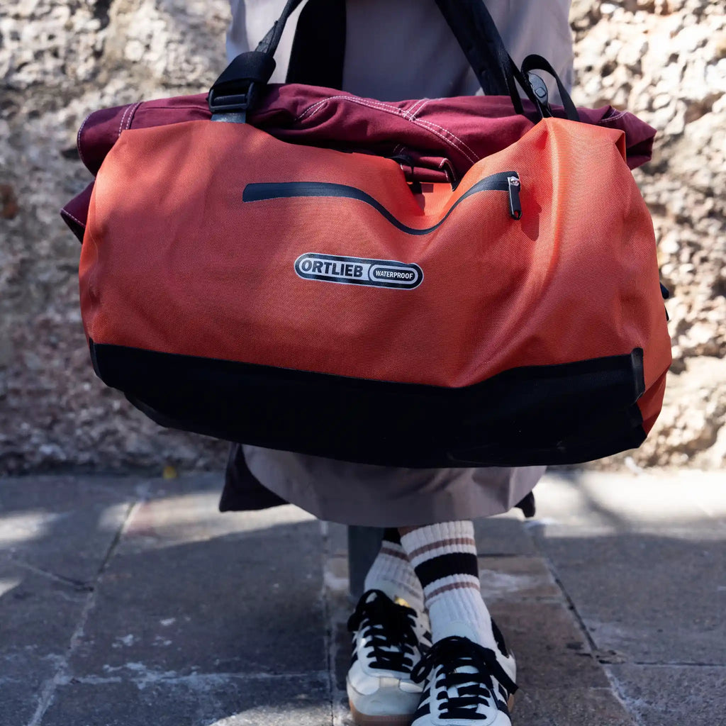 Ortlieb Duffel Lite Bag Adventure Travel Duffel Bag Rooibos Held by Woman