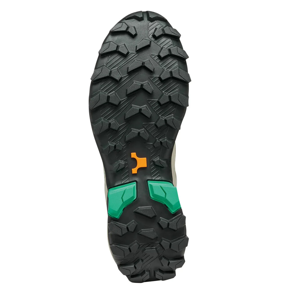 Close-up of a shoe sole with tread pattern and color accents on a white background