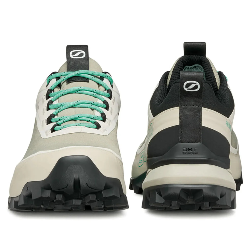 Pair of hiking shoes with green laces on a white background