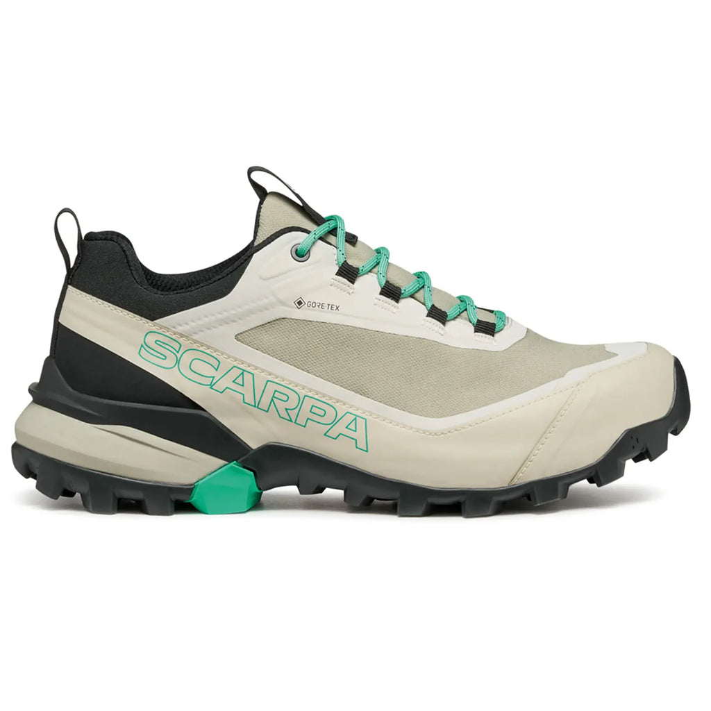 Beige and black hiking shoe with green accents on a white background