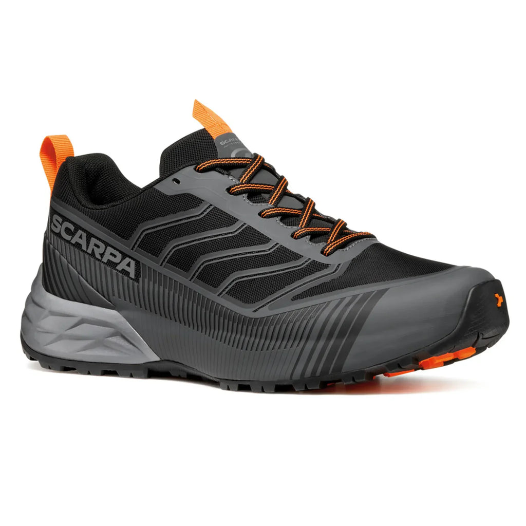Black and gray running shoe with orange accents on a white background
