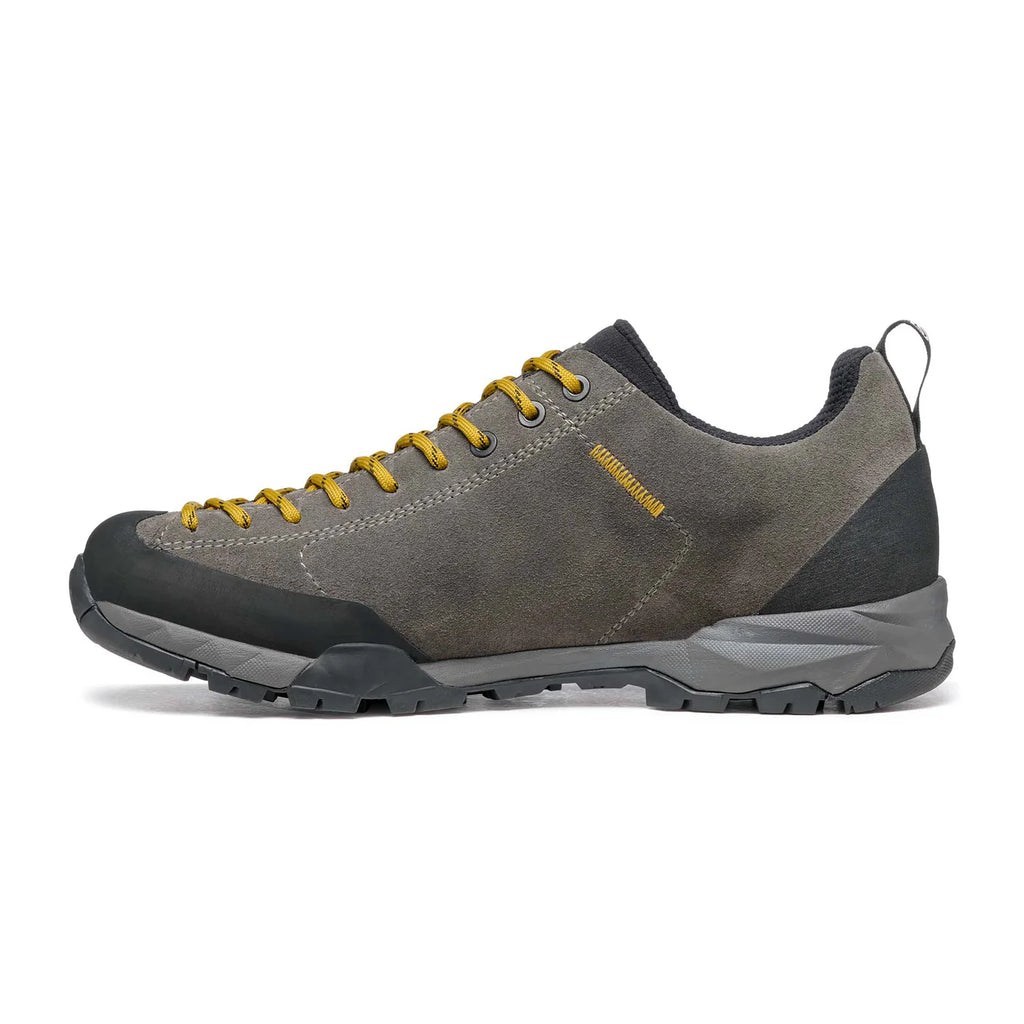 Gray hiking shoe with yellow laces on a white background
