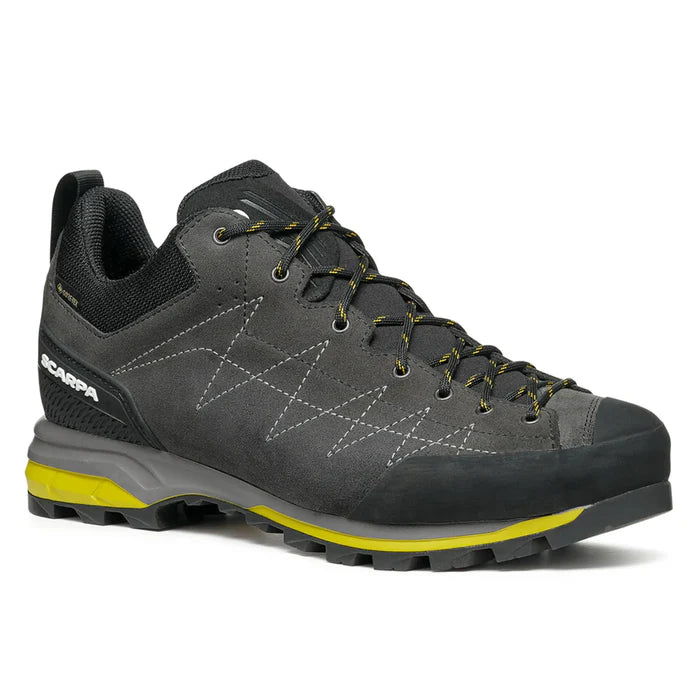 Gray hiking shoe with yellow accents on a white background