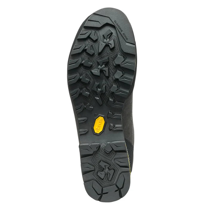Close-up of a black shoe sole with a yellow label on a white background