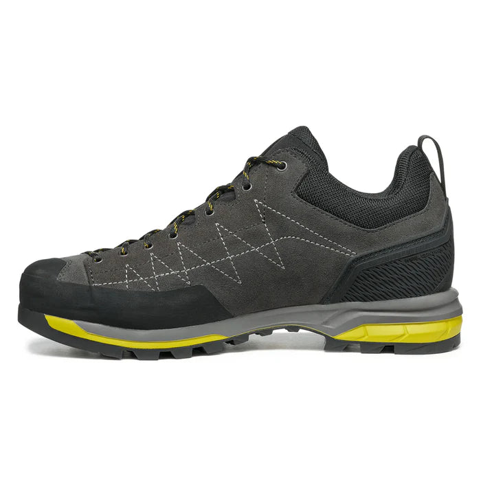Gray hiking shoe with yellow sole on a white background