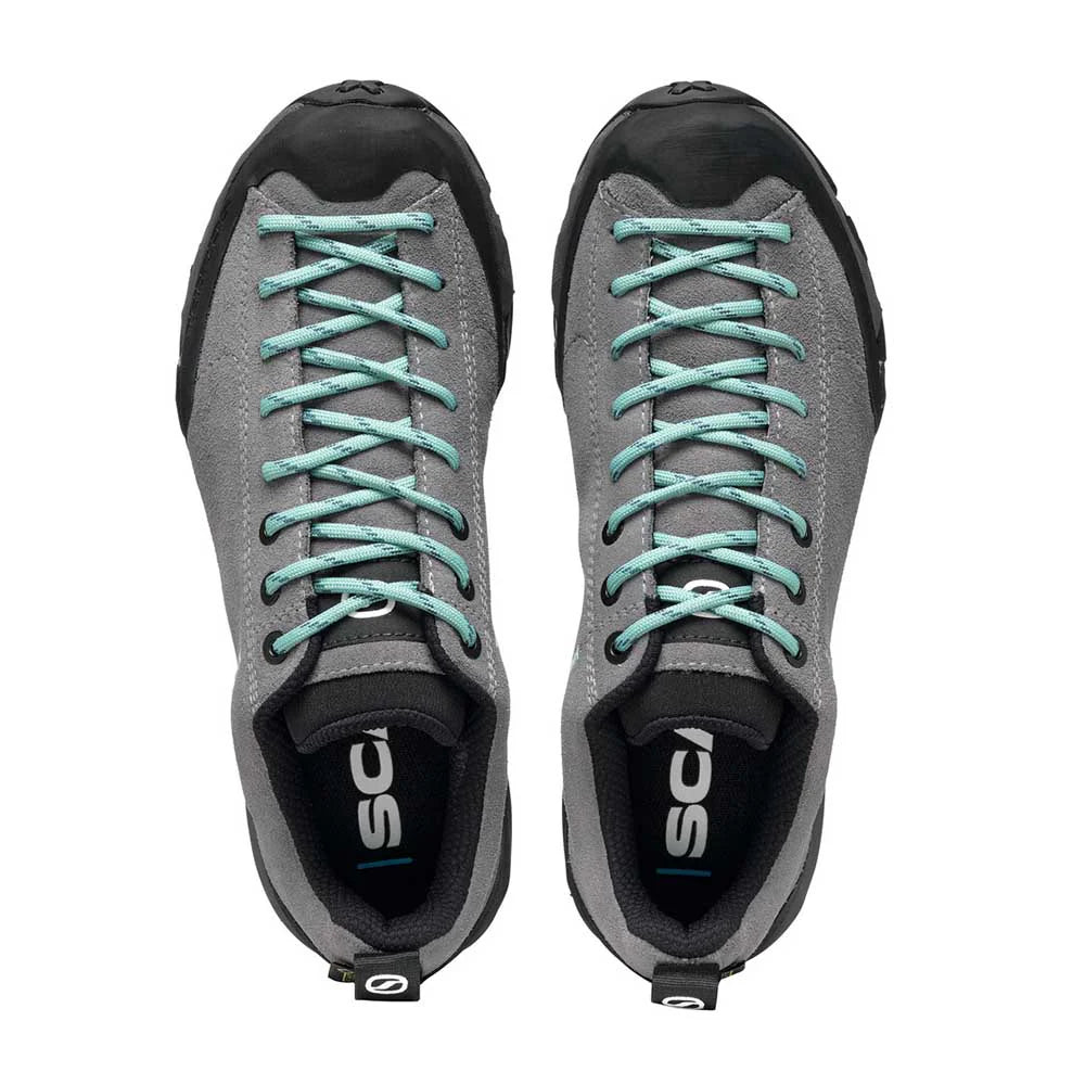 Pair of gray sneakers with teal laces on a white background