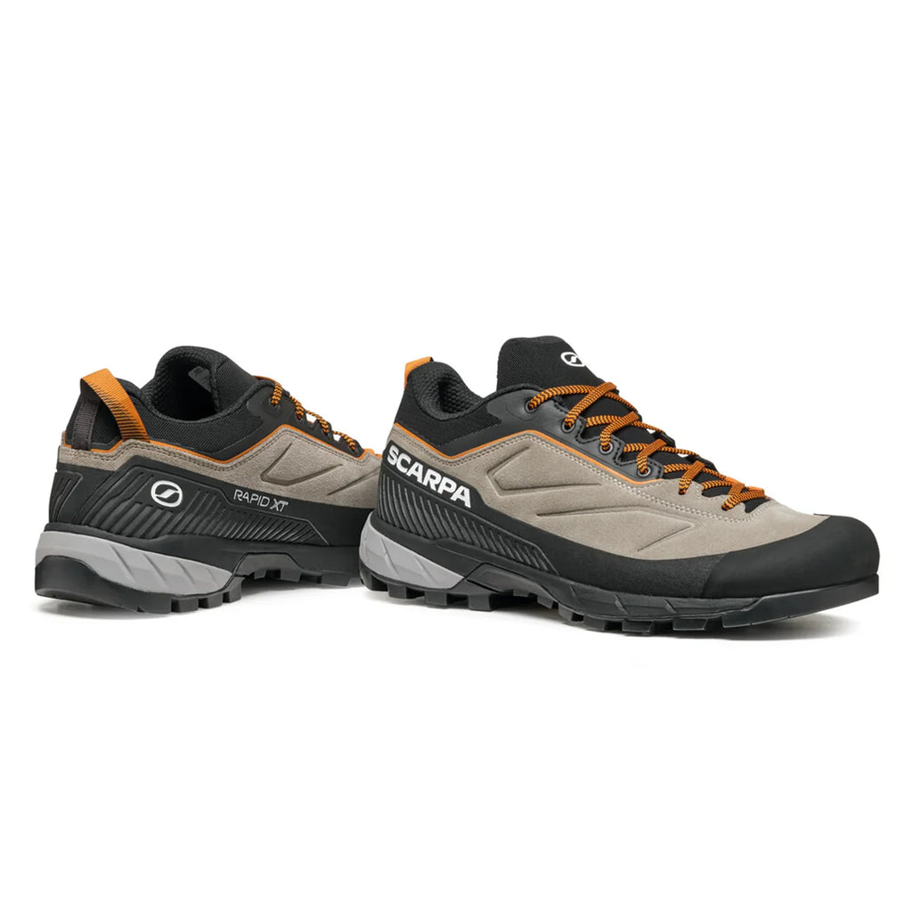 Pair of gray and black hiking shoes with orange accents on a white background