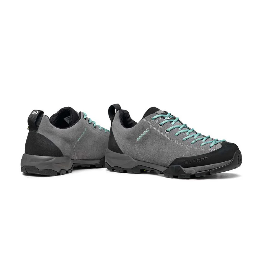 Pair of gray and black shoes with teal accents on a white background