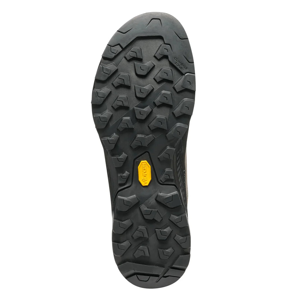 Close-up of a black shoe sole with a yellow label on a white background