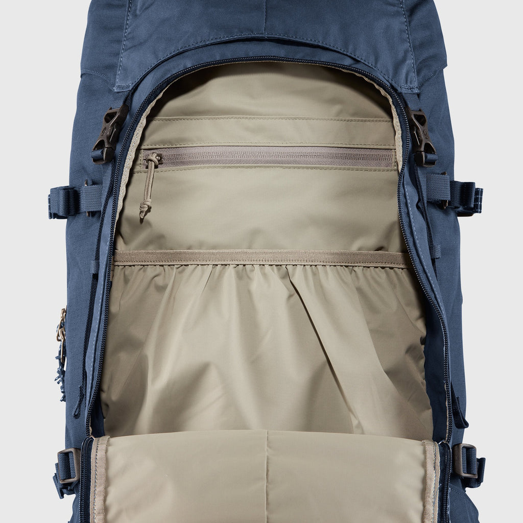 Backpack with open compartment showing beige interior on a light gray background